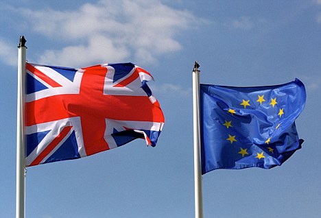 A United Kingdom flag flying next to a European Union flag